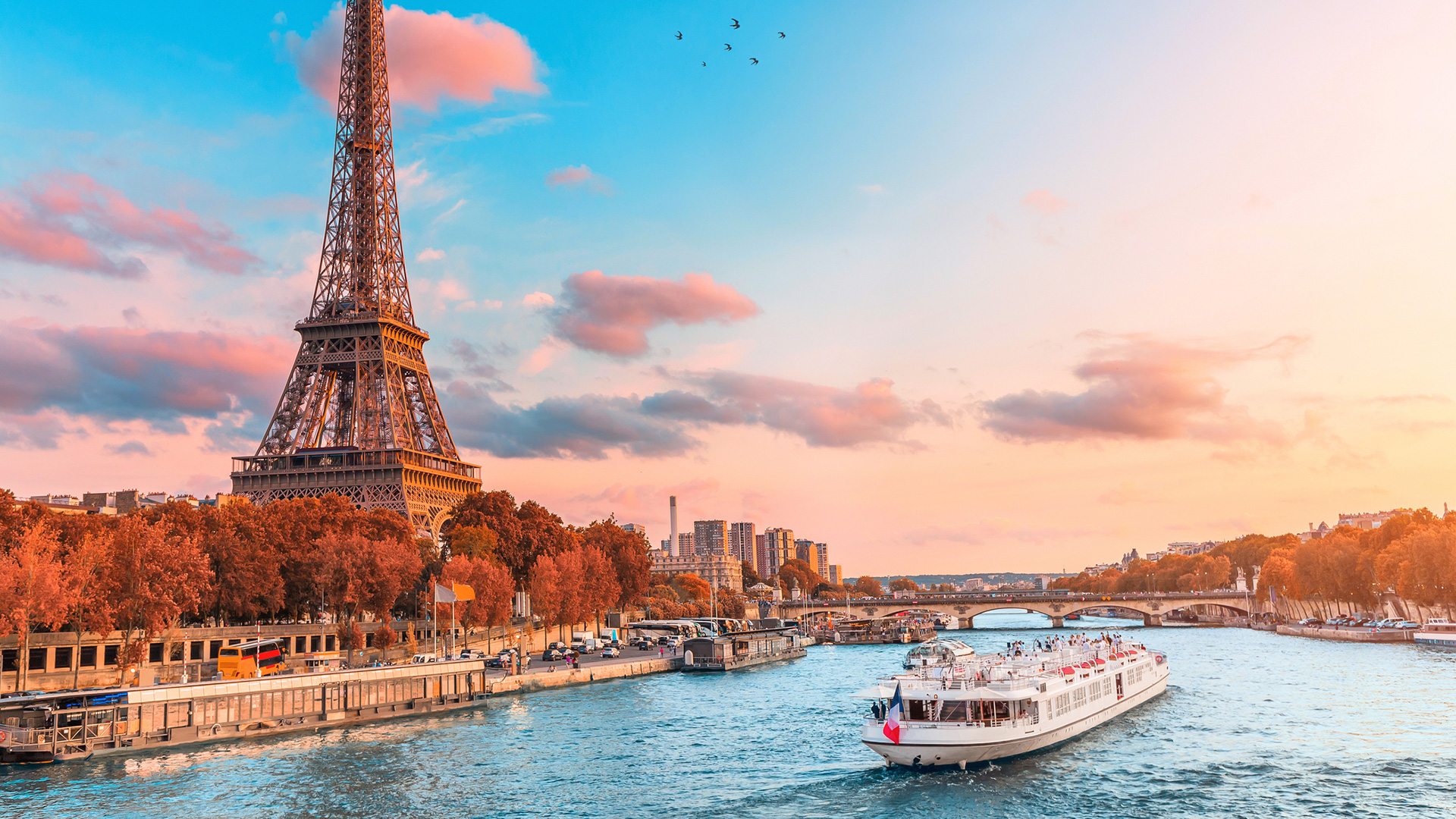 Tour boat on the Seine below the Eiffel Tower at sunset